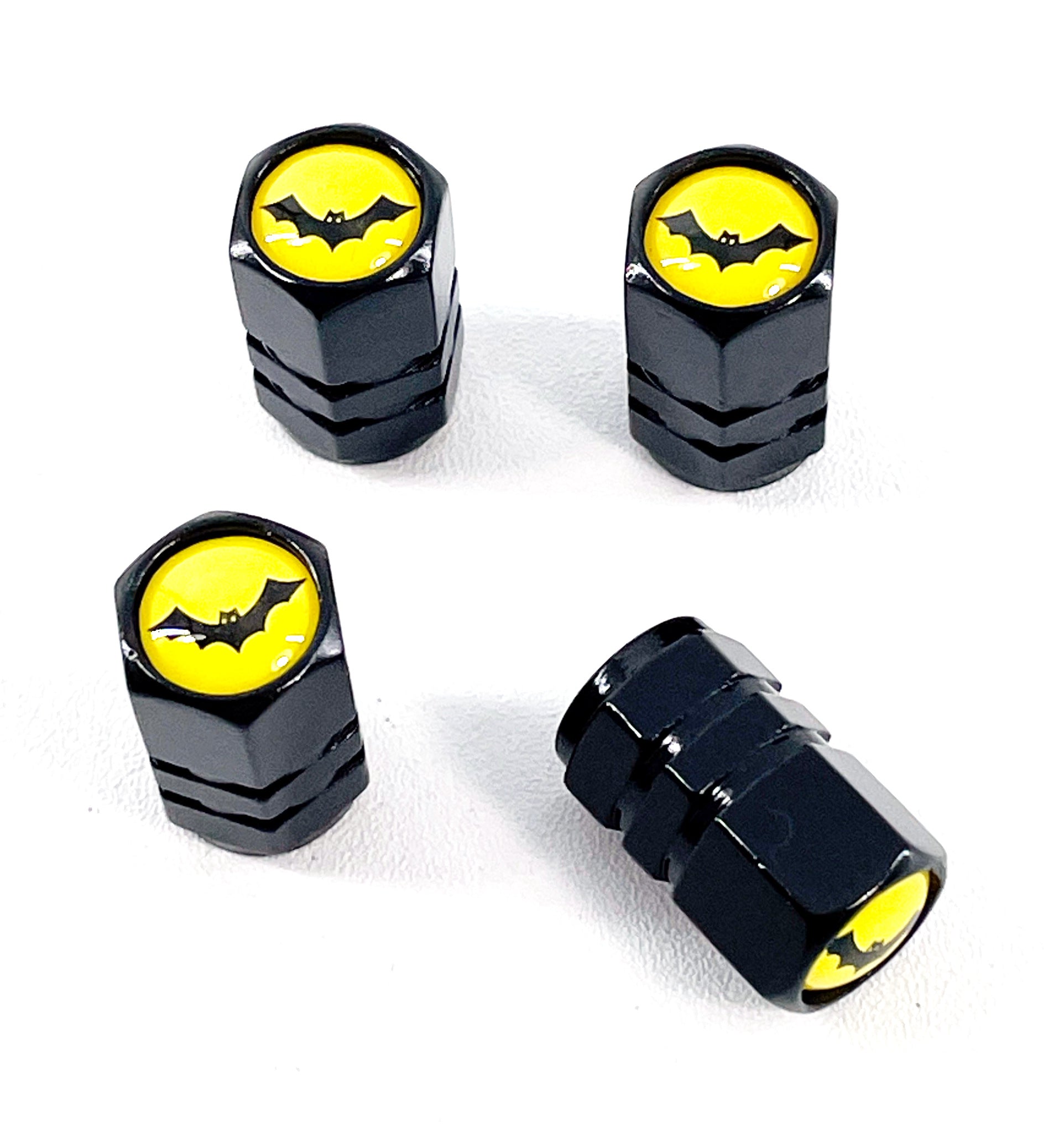 Set of 4 Black Anodized Aluminum Valve Stem Caps with Bat Logo on Yellow Background